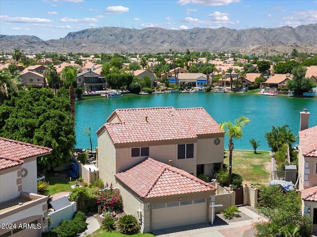 drone / aerial view with a water and mountain view