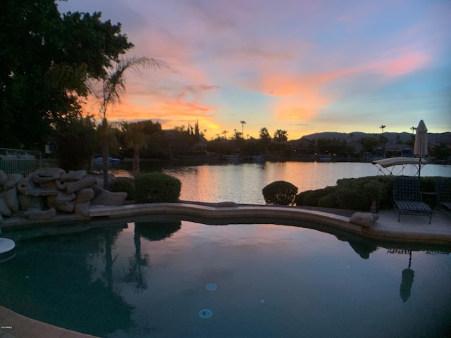 pool at dusk with a water view