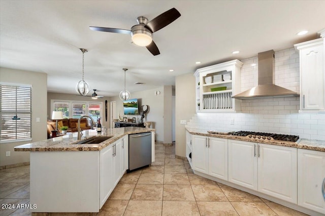 kitchen with white cabinets, sink, wall chimney exhaust hood, tasteful backsplash, and stainless steel appliances