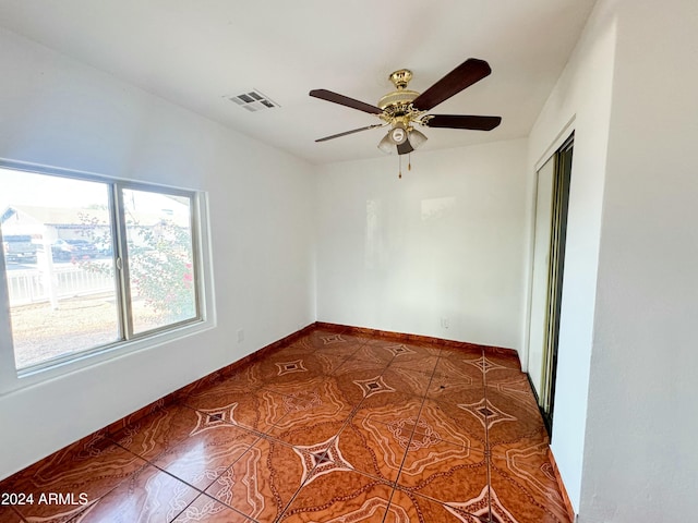 tiled empty room with ceiling fan