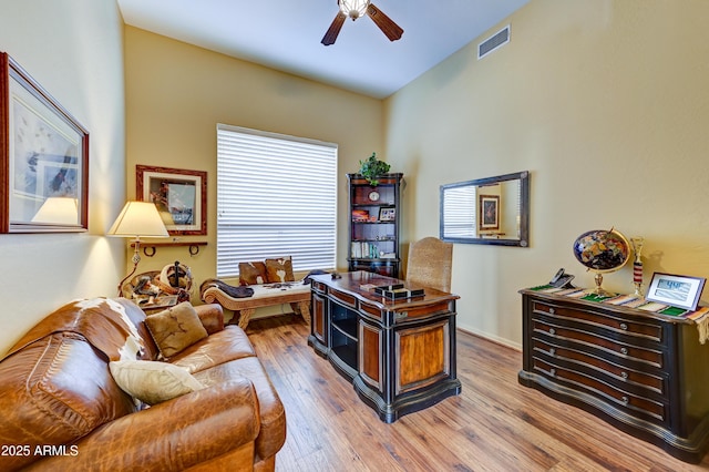 office area featuring light wood finished floors, visible vents, and a ceiling fan