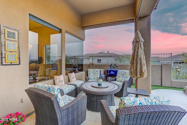 patio terrace at dusk featuring an outdoor living space