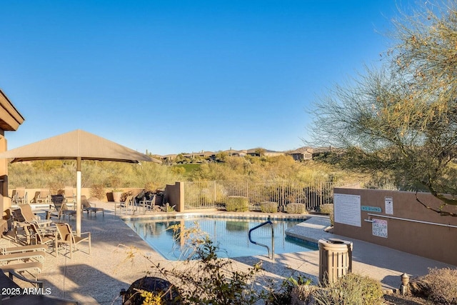 community pool featuring a patio and fence