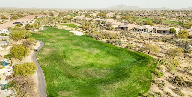 birds eye view of property featuring a mountain view, view of golf course, and a residential view