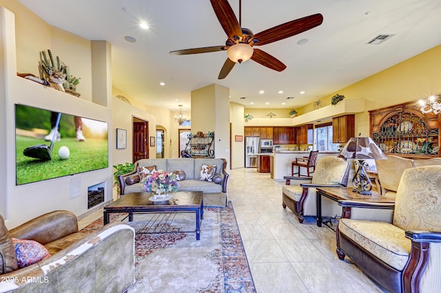 living area featuring ceiling fan with notable chandelier, visible vents, and recessed lighting