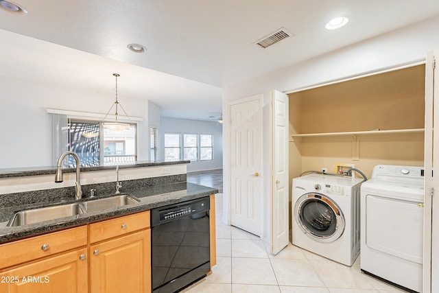 laundry area with laundry area, visible vents, separate washer and dryer, a sink, and light tile patterned flooring