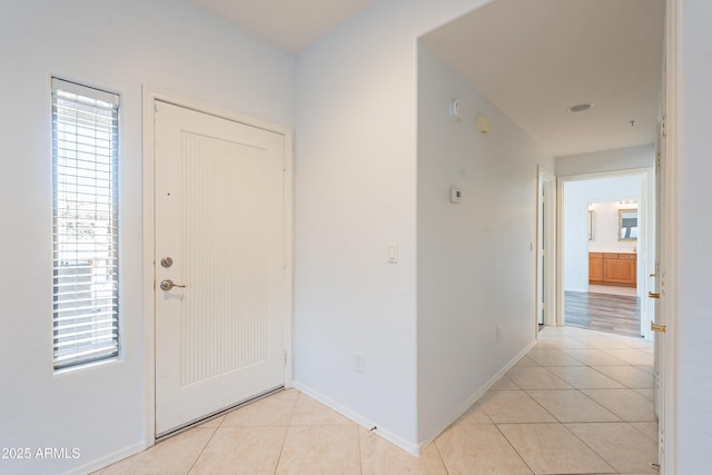 entrance foyer with baseboards and light tile patterned flooring