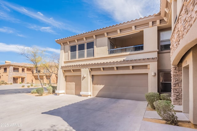 view of front of property featuring a garage, driveway, and stucco siding