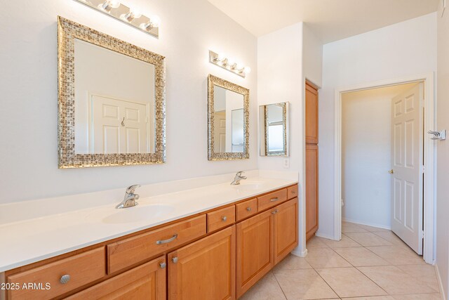 full bath featuring double vanity, a sink, and tile patterned floors