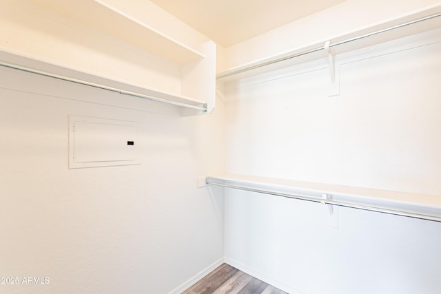 spacious closet with wood finished floors and electric panel