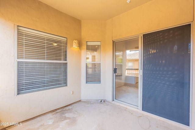 entrance to property featuring a patio and stucco siding