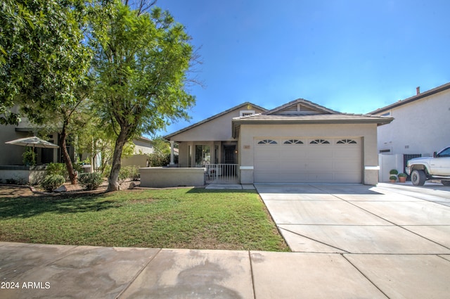 ranch-style house with a garage and a front lawn