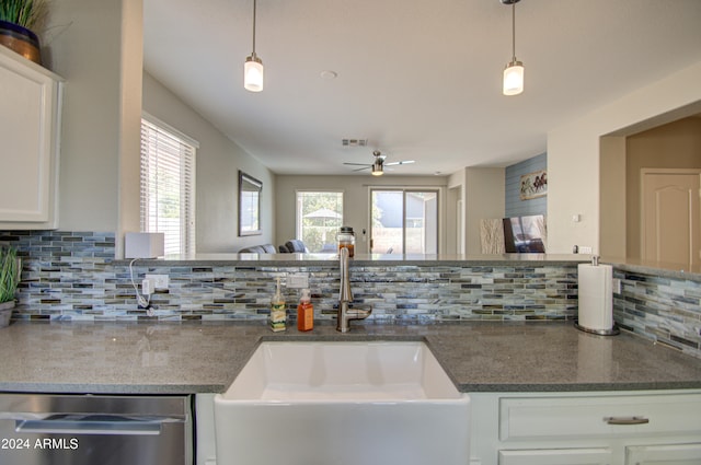 kitchen featuring a wealth of natural light, sink, white cabinetry, and stainless steel dishwasher