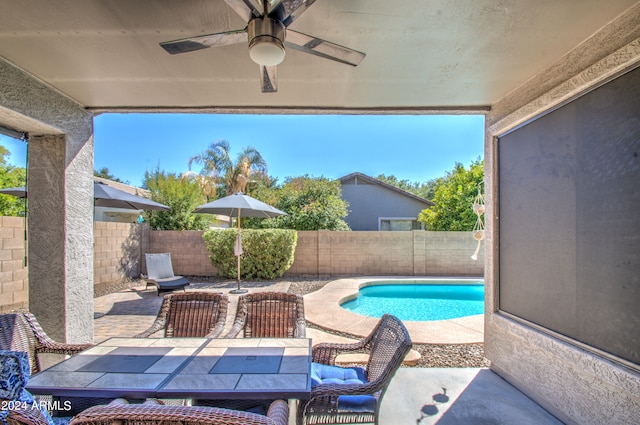 view of pool with ceiling fan and a patio