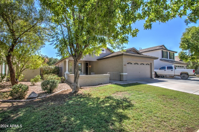 view of front of property with a garage and a front lawn