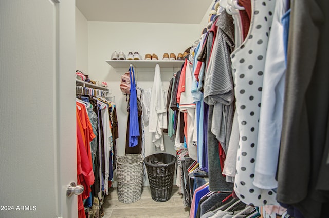 spacious closet featuring hardwood / wood-style flooring