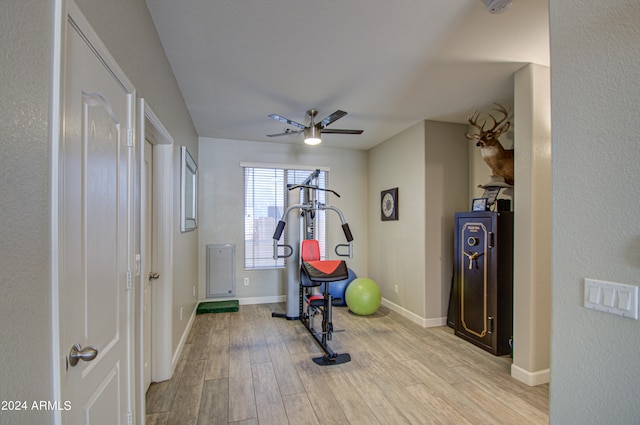 workout area featuring light hardwood / wood-style flooring and ceiling fan