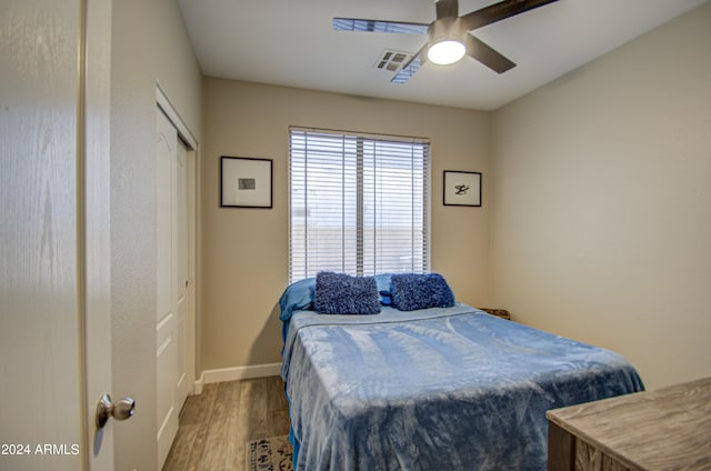 bedroom with wood-type flooring and ceiling fan