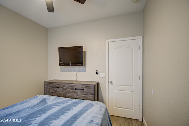 bedroom with light hardwood / wood-style flooring and ceiling fan