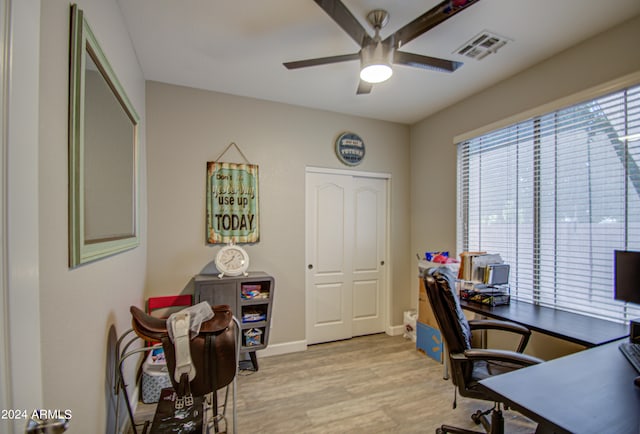 home office featuring light wood-type flooring and ceiling fan