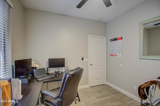 home office featuring light hardwood / wood-style flooring and ceiling fan