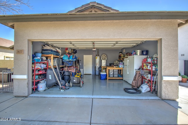 garage with water heater and white fridge