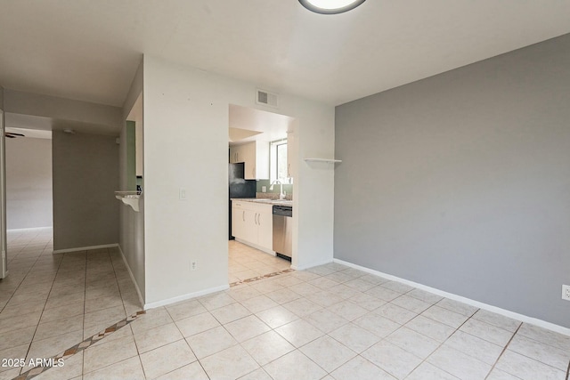 spare room featuring sink and light tile patterned floors