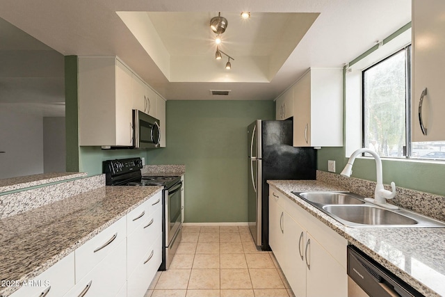 kitchen featuring white cabinets, sink, a raised ceiling, and stainless steel appliances