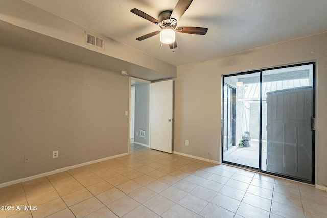 spare room with ceiling fan and light tile patterned floors