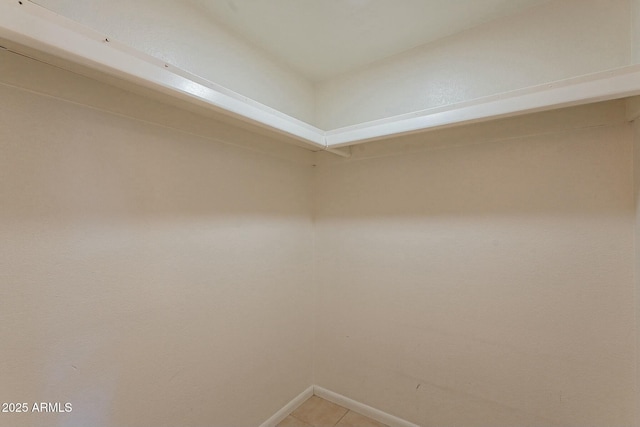 spacious closet with light tile patterned floors