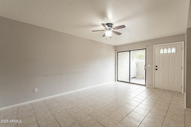 tiled empty room featuring ceiling fan