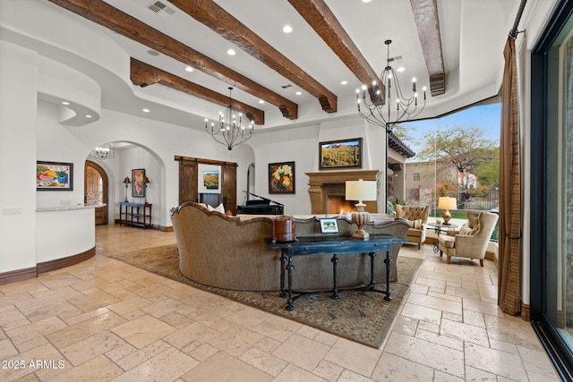 living room featuring a towering ceiling, beam ceiling, and a chandelier