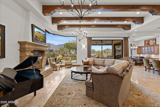 living room featuring a wealth of natural light, a fireplace, and a chandelier