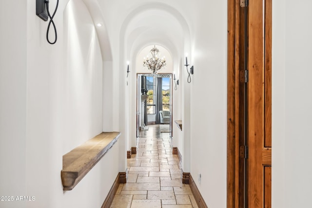 hallway featuring an inviting chandelier