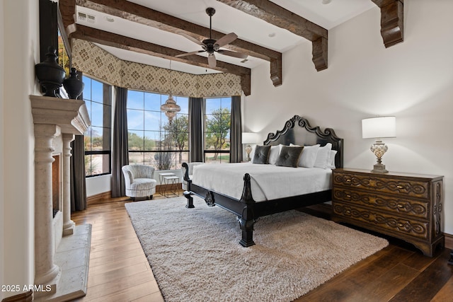 bedroom with wood-type flooring and beam ceiling