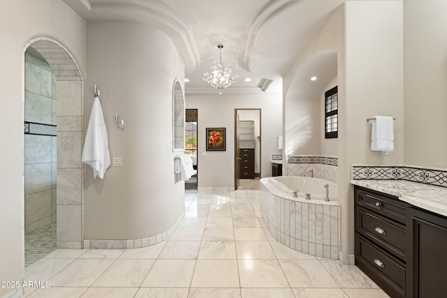 bathroom with vanity, ornamental molding, tiled bath, and an inviting chandelier