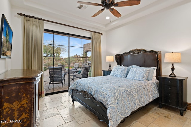 bedroom with a raised ceiling, access to outside, and ceiling fan