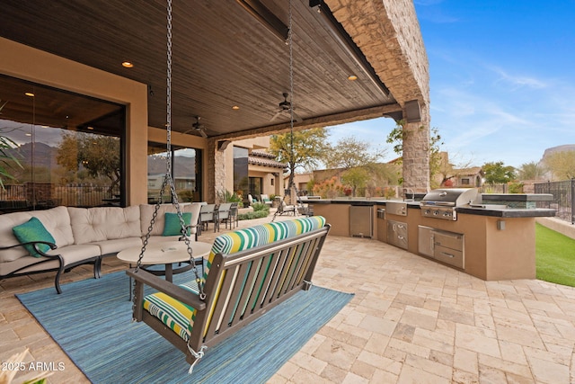 view of patio / terrace with ceiling fan, area for grilling, a grill, and an outdoor hangout area