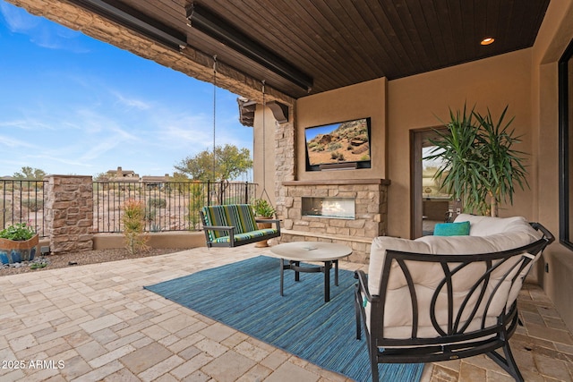 view of patio with an outdoor stone fireplace