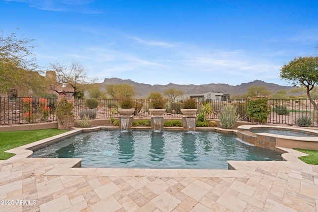 view of swimming pool featuring an in ground hot tub, a mountain view, pool water feature, and a patio