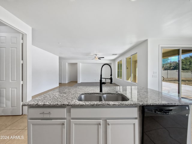 kitchen featuring dishwasher, light stone countertops, sink, and white cabinetry