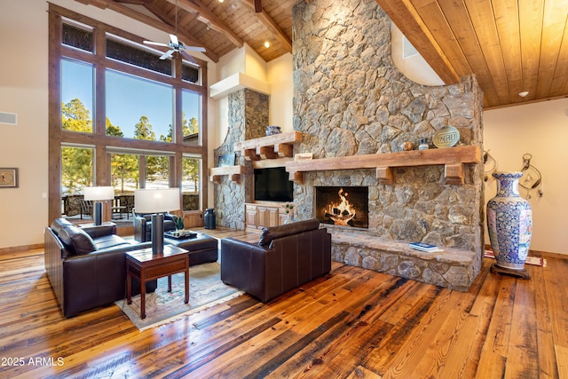 living room with a stone fireplace, wooden ceiling, visible vents, and hardwood / wood-style floors