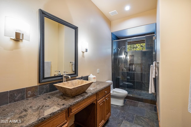 full bath featuring visible vents, a stall shower, toilet, and vanity