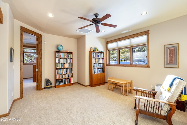 living area featuring recessed lighting, visible vents, a wealth of natural light, and baseboards