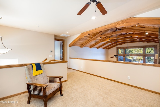 sitting room featuring vaulted ceiling, visible vents, baseboards, and light carpet