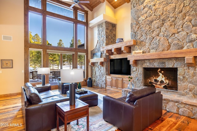 living area featuring hardwood / wood-style floors, wood ceiling, and a fireplace