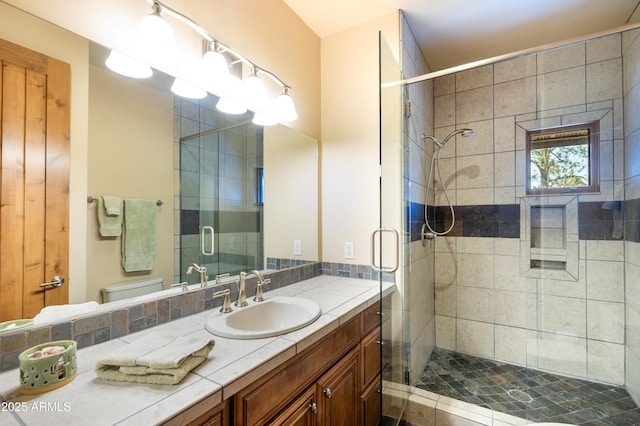 full bathroom with vanity, a shower stall, and toilet