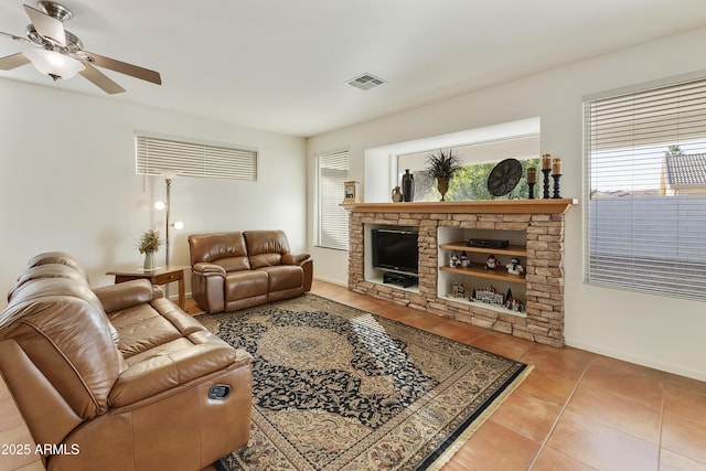 tiled living room with ceiling fan