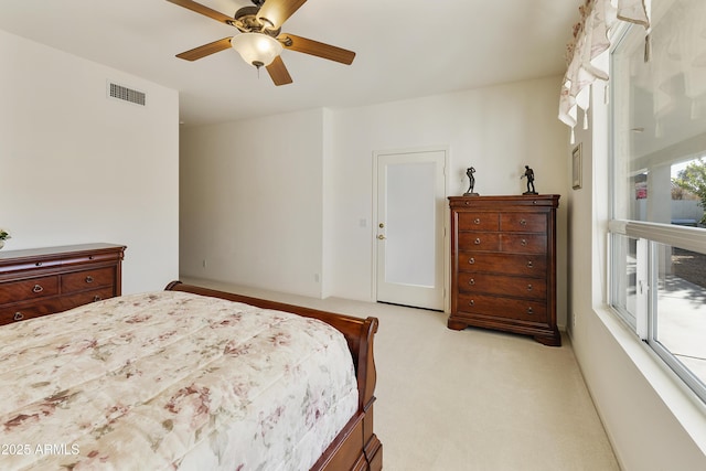 carpeted bedroom with ceiling fan and multiple windows