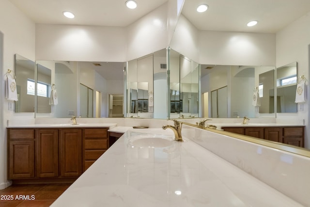 bathroom featuring a towering ceiling and vanity